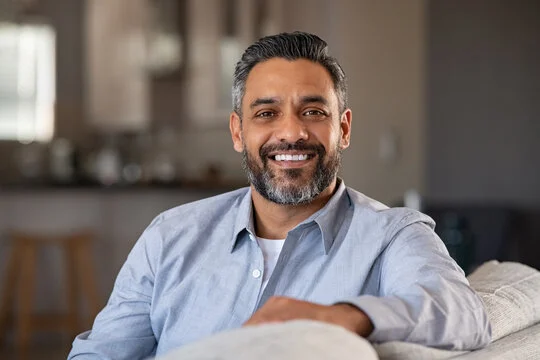 Portrait of a smiling mature man representing verified user satisfaction, healthy hearing recovery, and lifestyle quality.
