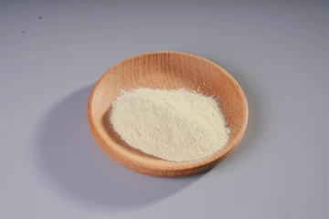 Bifidobacterium Infantis probiotic culture powder extract presented in a small round wooden bowl.