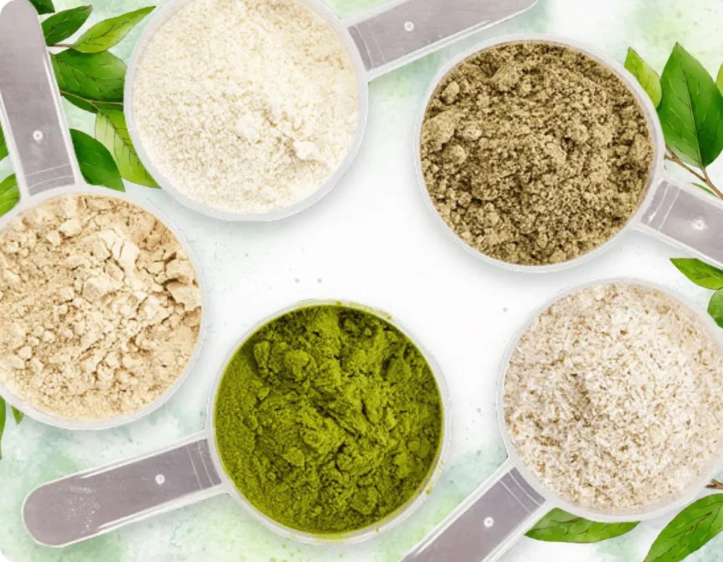 Top view of healthy green powders, natural fibers, and probiotic extracts in silver measuring spoons for dental health.